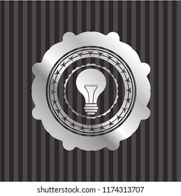 light bulb icon inside silvery shiny badge