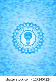 light bulb icon inside sky blue emblem with mosaic background