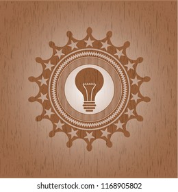 light bulb icon inside vintage wooden emblem