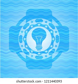 light bulb icon inside water style emblem.