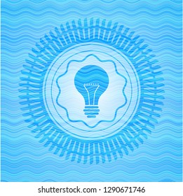 light bulb icon inside water wave representation emblem.