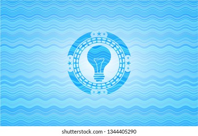 light bulb icon inside water wave representation badge.