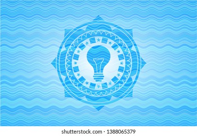 light bulb icon inside water wave concept badge.