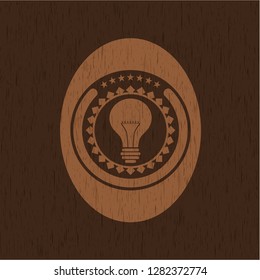 light bulb icon inside wood badge or emblem