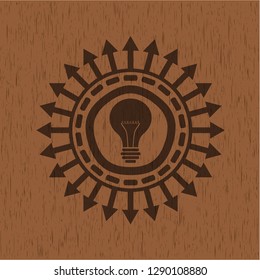 light bulb icon inside wood badge or emblem