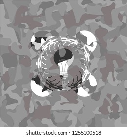light bulb icon on grey camo pattern