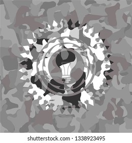 light bulb icon on grey camouflaged texture