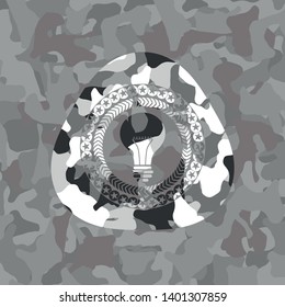 light bulb icon on grey camouflaged pattern