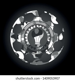 light bulb icon on grey camouflage texture