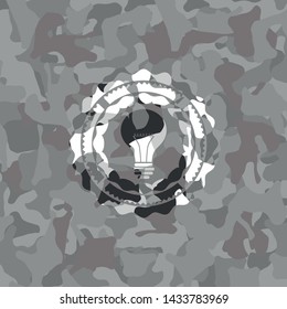 light bulb icon on grey camouflage texture