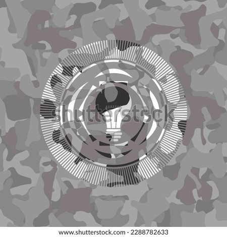 light bulb icon on grey camo texture. 