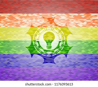 light bulb icon on mosaic background with the colors of the LGBT flag