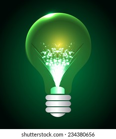 Light bulb illuminated on green background.