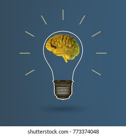 Light bulb illustration with golden low poly brain glowing on dark blue background