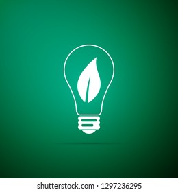 Light bulb with leaf icon isolated on green background. Eco energy concept. Flat design. Vector Illustration