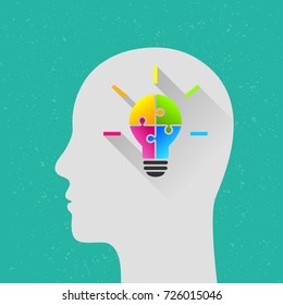 Light bulb made of colorful puzzle with human head as thinking and innovation concept. Flat design with long shadow.