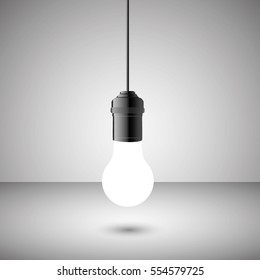 Light bulb on a gray background, light white