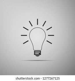 Light bulb with rays shine icon isolated on grey background. Energy and idea symbol. Lamp electric. Flat design. Vector Illustration