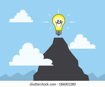 Light bulb at the top of a mountain 