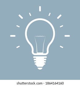 Bombilla de luz con un golpe blanco sobre un fondo azul. Una bombilla siempre es una buena idea.