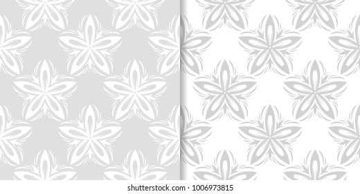 Light gray floral backgrounds. Set of seamless patterns for textile and wallpapers