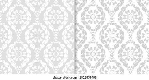Light gray floral backgrounds. Set of seamless patterns for textile and wallpapers