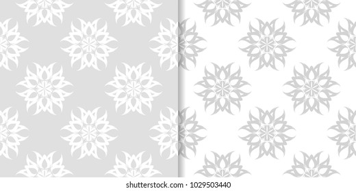 Light gray floral backgrounds. Set of seamless patterns for textile and wallpapers