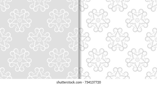 Light gray floral backgrounds. Set of seamless patterns for textile and wallpapers