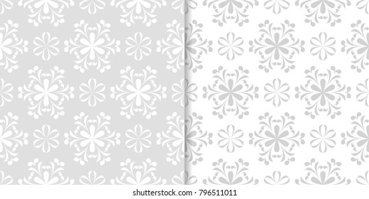 Light gray floral backgrounds. Set of seamless patterns for textile and wallpapers
