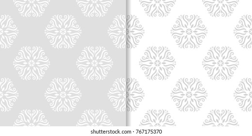 Light gray floral ornamental designs. Set of seamless patterns for textile and wallpapers