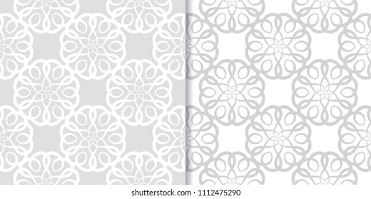 Light gray and white floral ornaments. Set of seamless patterns for textile and wallpapers