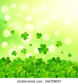 Light green vector background with clovers