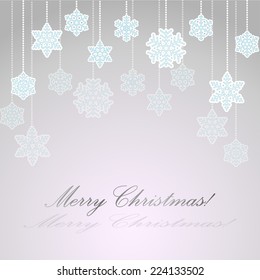 Light grey background with paper snowflakes on a string of beads for greeting cards for  Christmas