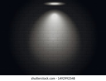 Light on a black brick wall. Transparent white light illuminates the dark background.