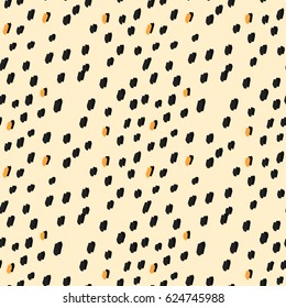 light painted color pattern of orange and black spots on a beige background