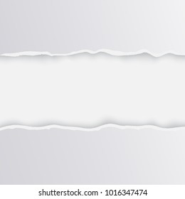 Light paper is unevenly torn in the center with torn uneven edges and shadow