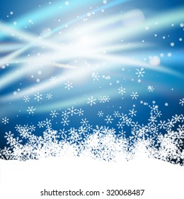 light rays with sparkles on snowflakes winter background