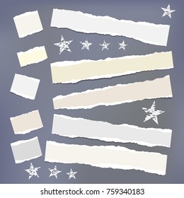 Light ripped strips, notebook, note paper with stars for text or message stuck on dark gray background.