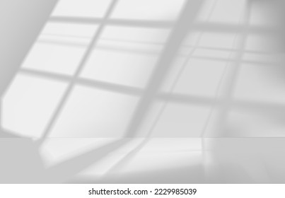 La luz brilla por el estudio o por la ventana de la habitación en el suelo y la pared, con un fondo gris y blanco.
