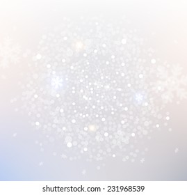 Light silver abstract Christmas background with blurred white snowflakes