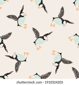 Light tones seamless pattern with hand drawn doodle puffin bird silhouettes. Pink pastel background. Flat vector print for textile, fabric, giftwrap, wallpapers. Endless illustration.