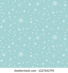 Light winter christmas seamless pattern with small snowflakes on light blue background