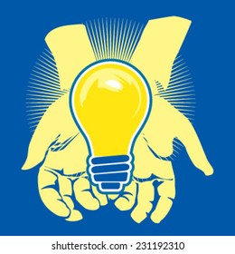 A lightbulb held by hands.
