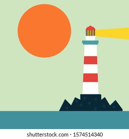 Lighthouse on the rocky shore of the sea. The sun is leaning toward the horizon. The lantern was lit at the lighthouse.