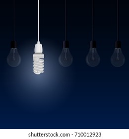 Lighting energy saving lamp among other light bulbs on a blue background