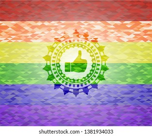 like icon inside emblem on mosaic background with the colors of the LGBT flag