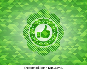 like icon inside green emblem with triangle mosaic background