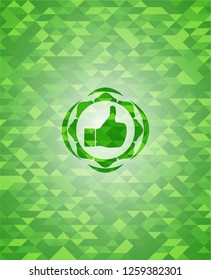 like icon inside green emblem with triangle mosaic background