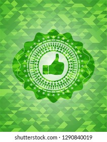 like icon inside green emblem. Mosaic background