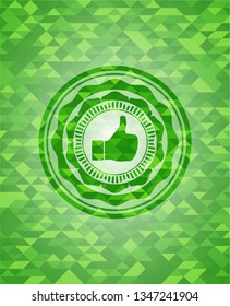 like icon inside green emblem. Mosaic background